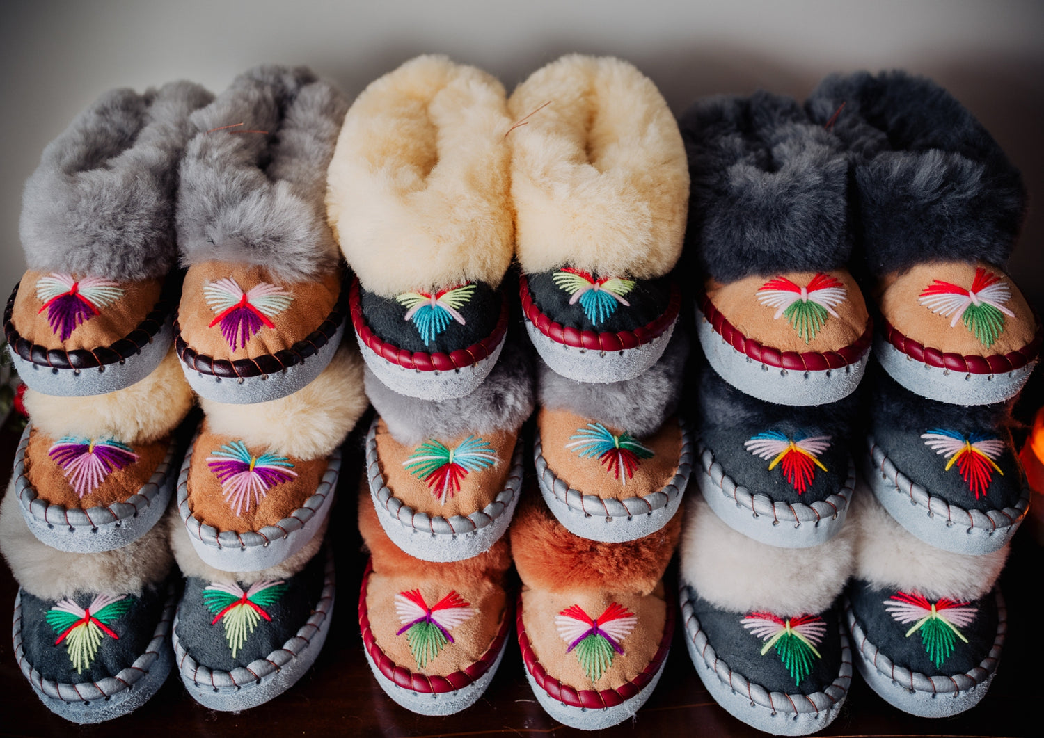 Collection of sheepskin slippers,  embroidered traditional indoor moccasins in various colours