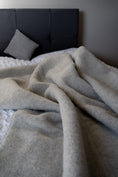 Load image into Gallery viewer, Grey thick, large and very warm pure merino wool fibre blanket, labeled with Woolmark high quality tag. looks very warm, comfortable and cosy