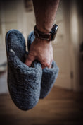 Load image into Gallery viewer, Men's grey wool slippers held in a man's hand