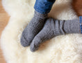 Load image into Gallery viewer, Gray color, wool socks for men, very warm. In the background cream sheepskin rug