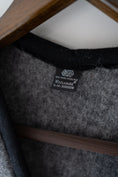 Load image into Gallery viewer, Woollen gilet with the Woolmark label on it. High quality merino vest in grey colour.
