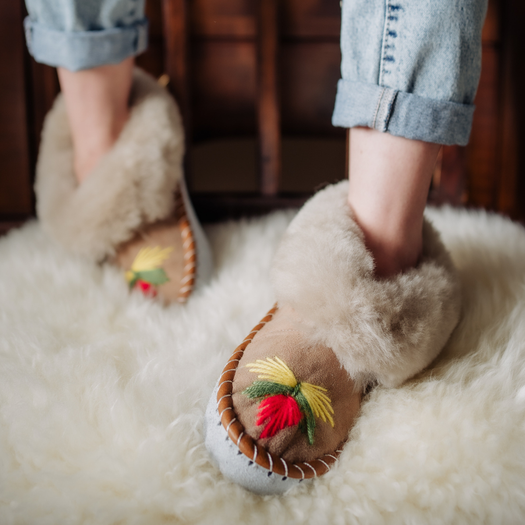 Sheepskin slippers on sheepskin rug