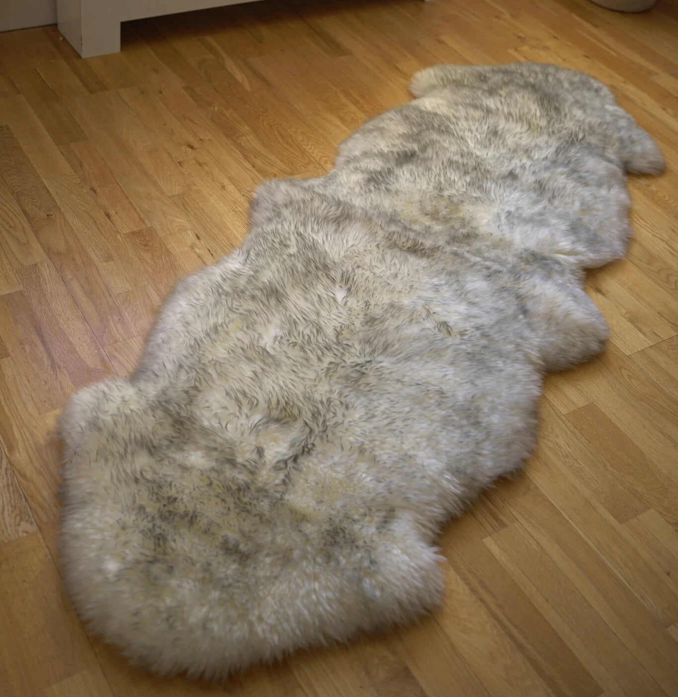 sheepskin rug cream and grey, on the floor, long fur skin