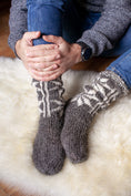 Load image into Gallery viewer, Man in woollen turtleneck and woollen knitted socks sitting on natural sheepskin rug. Men is feeling warm and cosy on winter time
