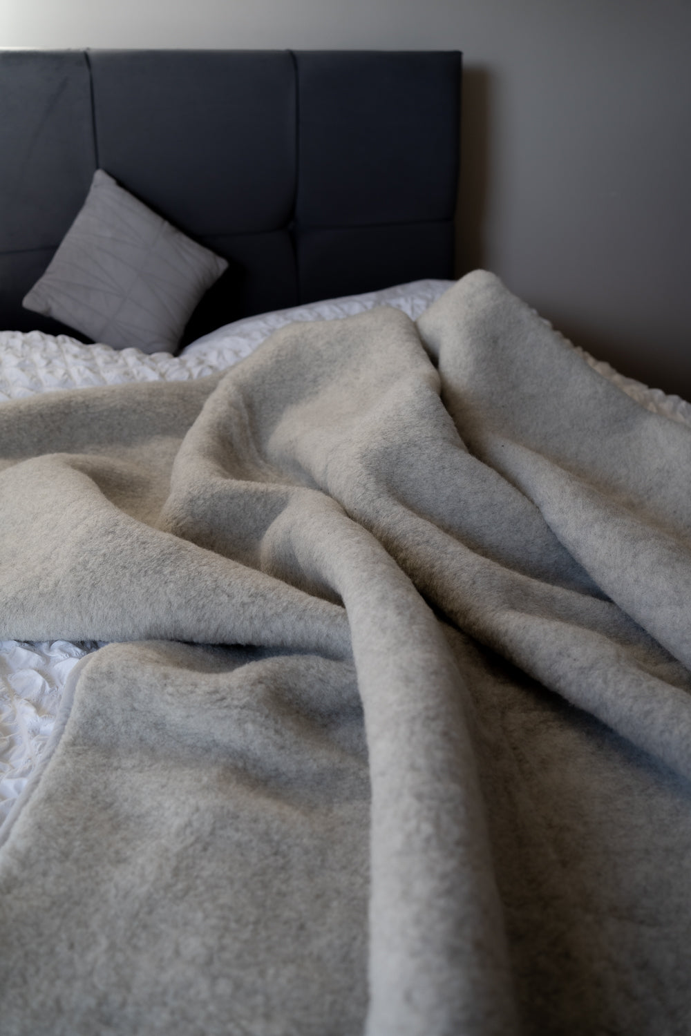 grey,Warm and cosy looking woollen blanket on the bed