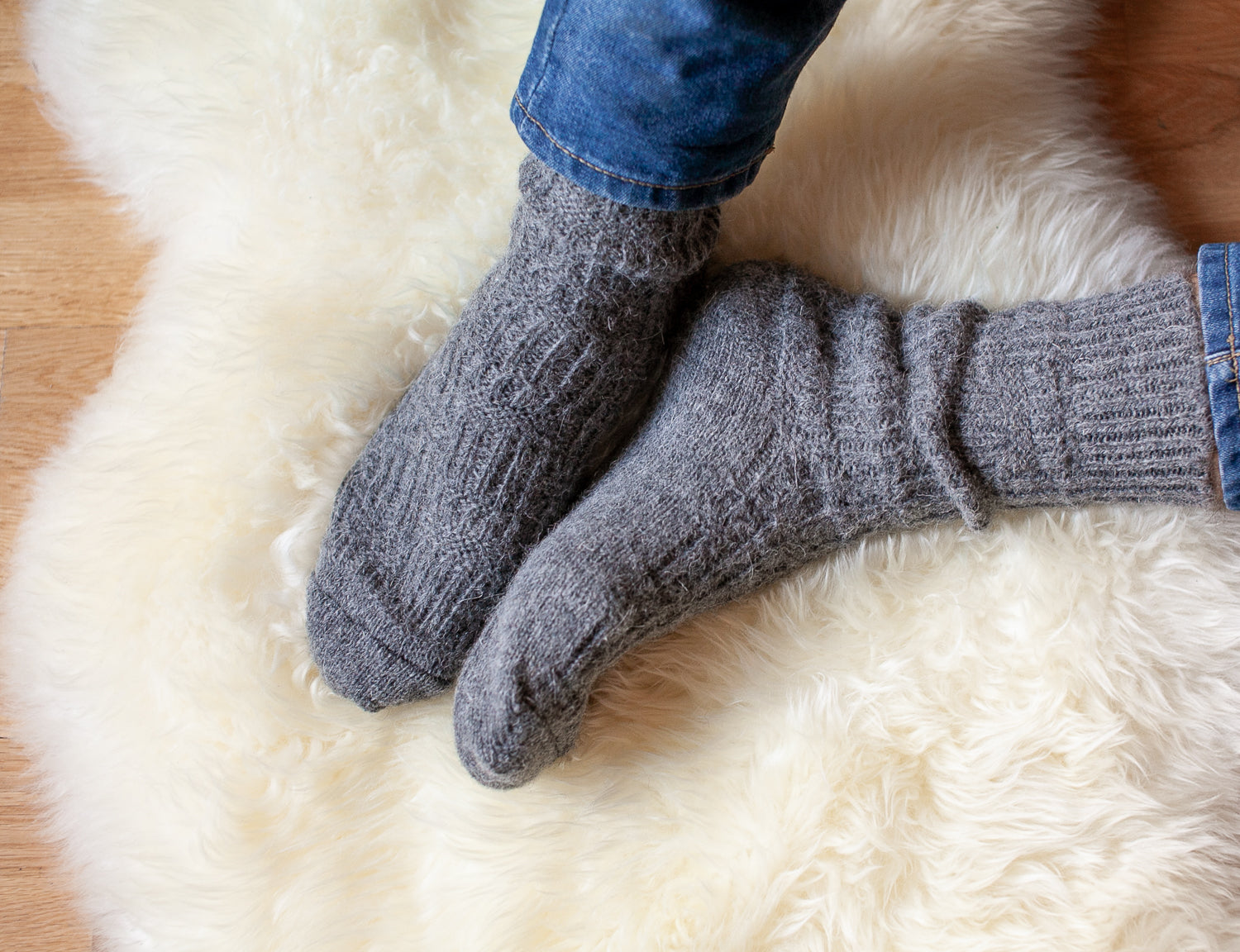 Gray color, wool socks for men, very warm. In the background cream sheepskin rug