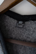 Load image into Gallery viewer, Woollen gilet with the Woolmark label on it. High quality merino vest in grey colour.
