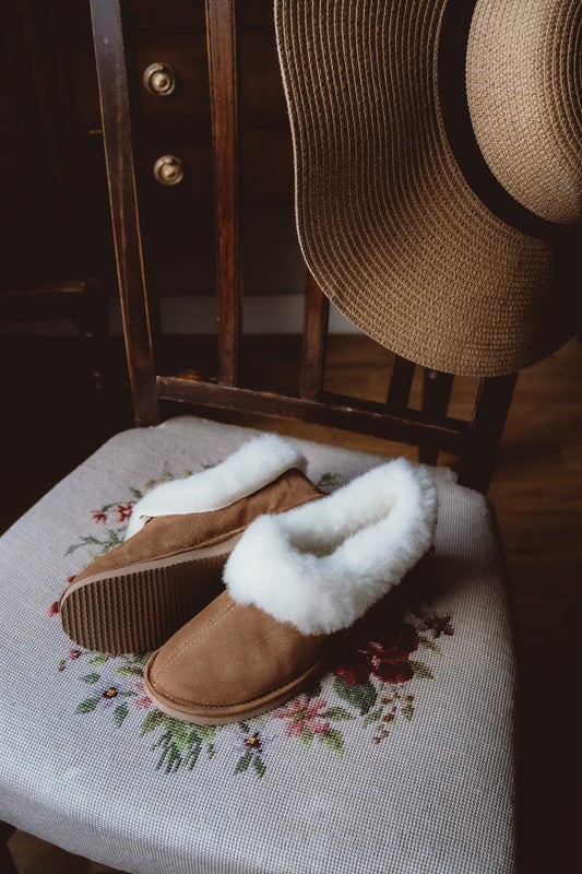Handmade women's caramel sheepskin slippers, featuring a cozy wool lining.