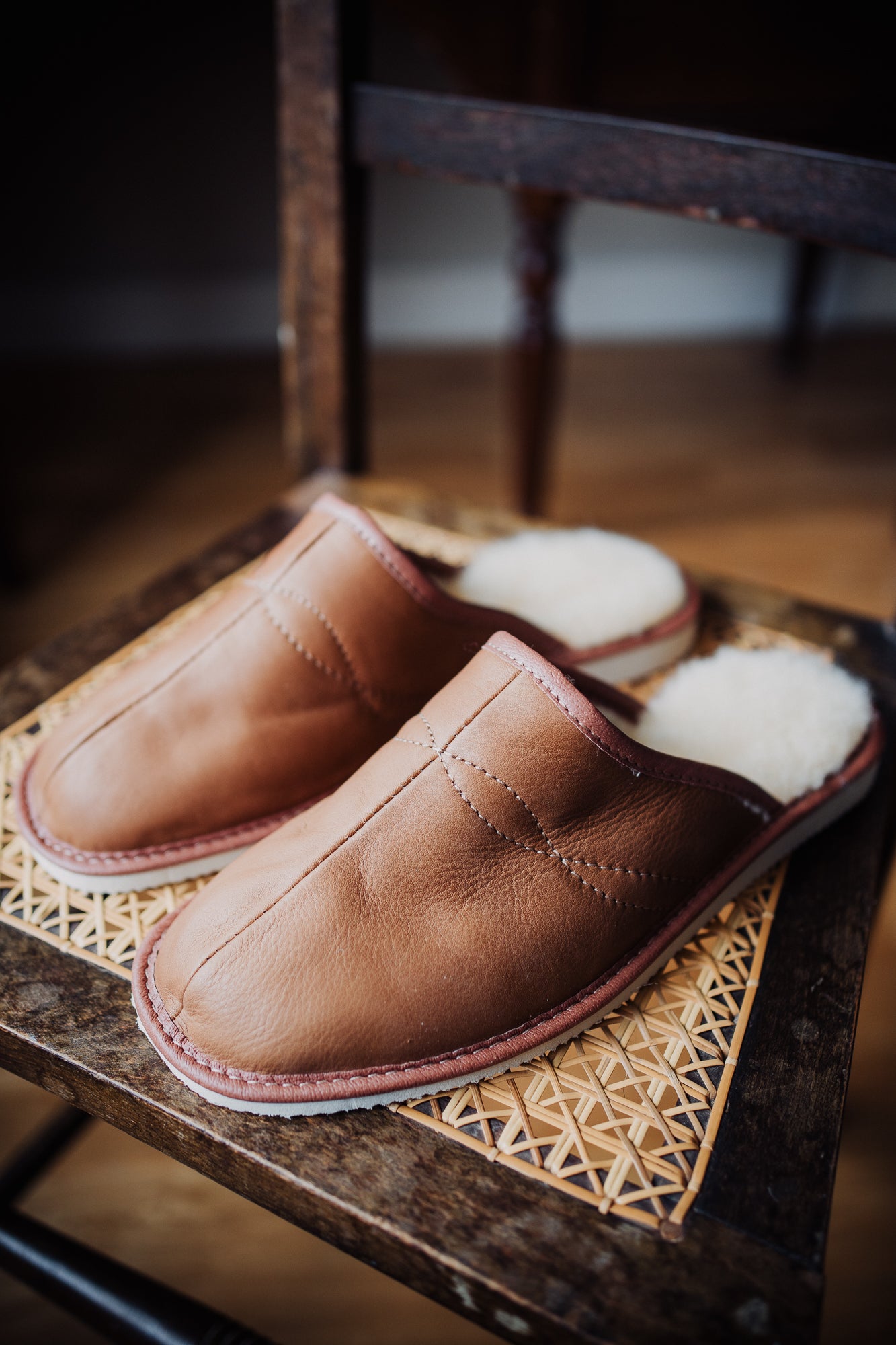 Close-up of sustainable leather men's slippers, showcasing their soft texture and intricate details.